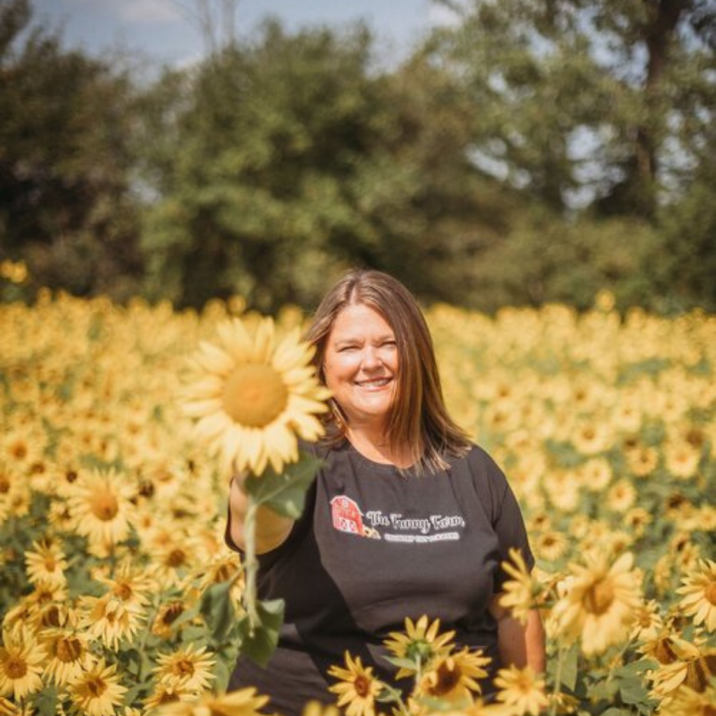 Owner of Funny Farm Country Cut Flowers Holding Sunflower